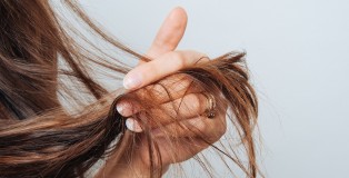 Girl holding her hair in her hand. Hair care concept. Shampoo. Haircut needed. - www.salonbusiness.co.uk